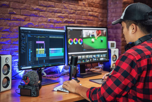 The man makes video editing. Video production. Color Correction. Sound editing. Film making. The work of a freelancer. Equipment filmmaking. Create videos. Program for video editing.